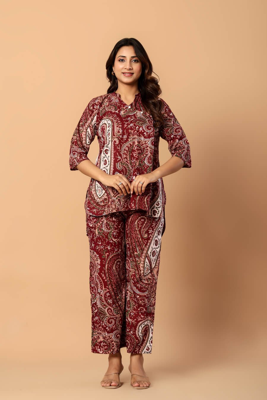 Woman wearing a maroon and ivory paisley print cotton tunic and matching straight pants — image 4
